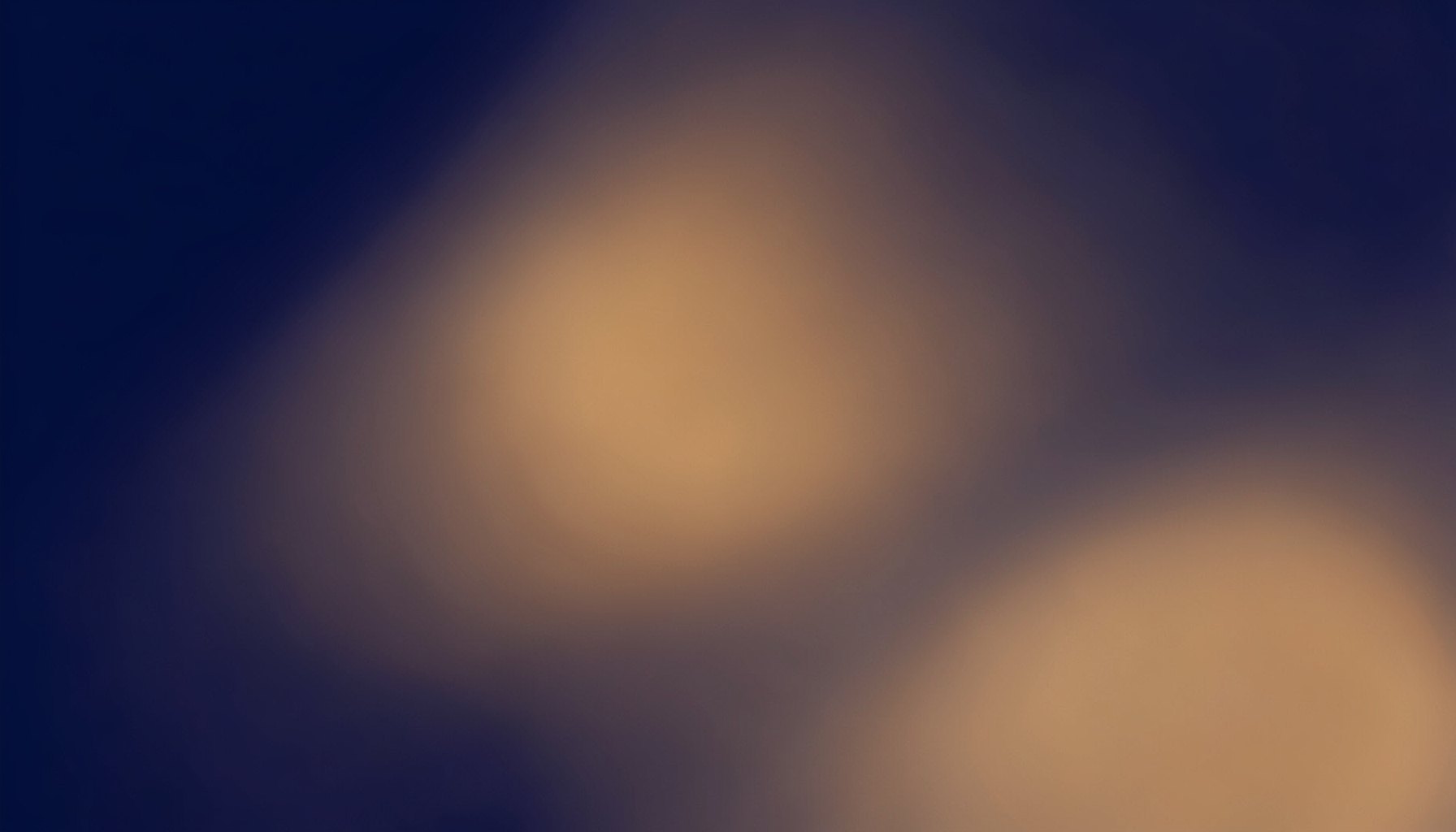 Abstract soft gradient composition in deep navy fading to warm amber, evoking a calm developer-focused atmosphere