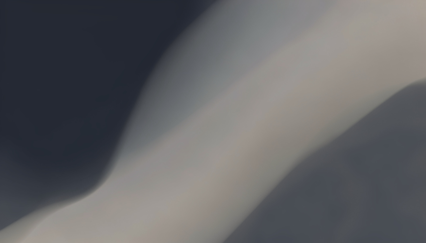 A muted abstract composition of deep slate, charcoal, and soft warm grey gradient shapes that evokes an early-2010s developer portal atmosphere without any people, logos, or text.